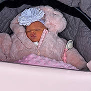 Arabella joined the competition — help win amazing prizes! baby, sleeping, stroller, pink, coat, headband, flower, quilted, blanket, cute, infant, face, peaceful, child, warm, clothing, portrait, closeup, soft, indoor