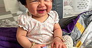 Moana is registered to the contest to win money with this photo: baby, blanket, bottle, bracelet, child, clothing, cozy, cute, expression, hair, happy, indoors, laundry_basket, pajamas, person, playpen, portrait, sitting, smiling, toddler