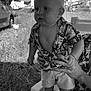 Ezéchias participe au concours pour gagner de l'argent avec cette photo : toddler, child, baby, shirt, shorts, hand, chair, outdoor, grass, van, tent, black_and_white, portrait, person, summer, support, field, patterned_clothing, barefoot, necklace
