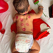Atharv is registered to the contest to win money with this photo: baby, back_view, balloon, black_thread, bracelet, cute, decor, diaper, flower, handmade_flower, infant, lipstick_marks, love_theme, lying_down, pillow, red_heart, skin, sleeping_position, toddler, white_sheet