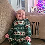 Waylon joined the competition — help win amazing prizes! baby, smiling, couch, onesie, penguin_pattern, christmas_tree, pillow, gift, holiday, indoor, cozy, child, festive, home, celebration, seated, happy, infant, decor, warm