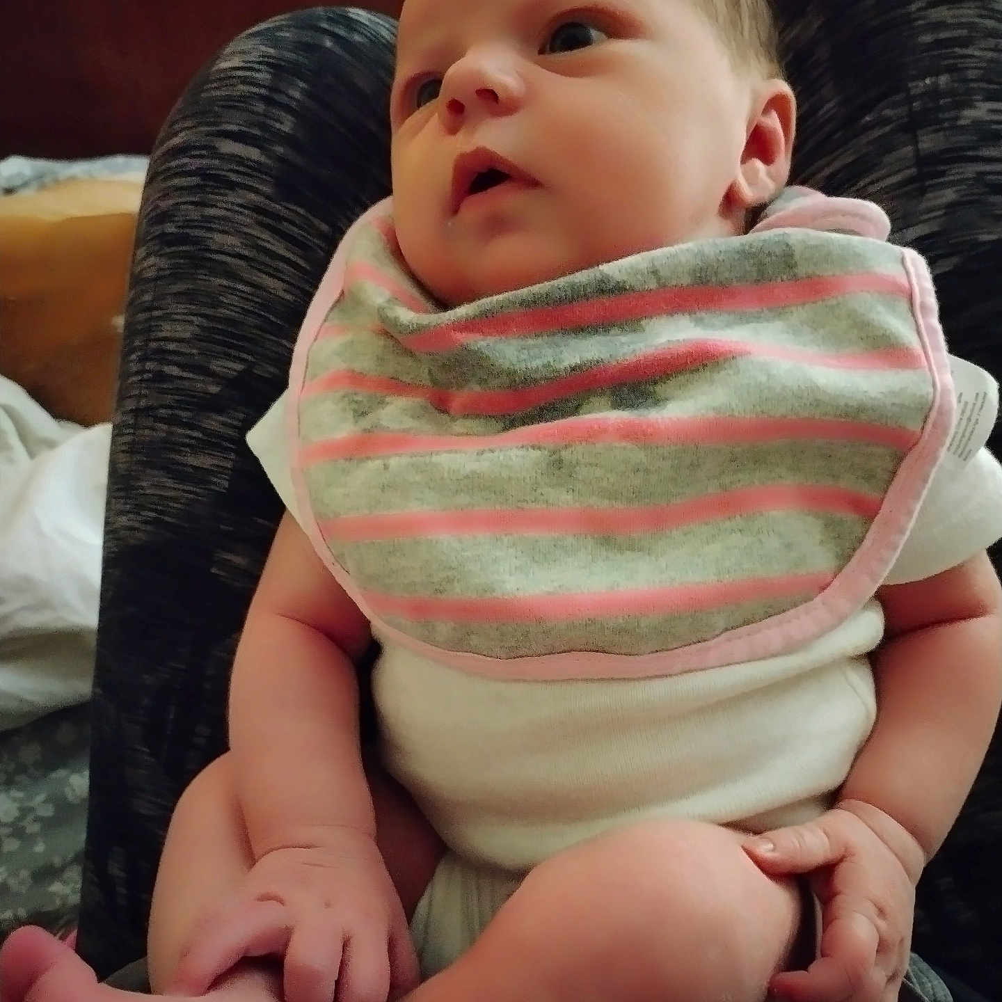 Jurnie is registered to the contest to win money with this photo: baby, bib, child, closeup, clothing, comfort, curious, expression, face, feet, hand, head, indoor, infant, lap, legs, person, sitting, skin, striped