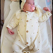 Adriana participe au concours pour gagner de l'argent avec cette photo : baby, infant, pacifier, headband, onesie, blanket, sleeping, heart_pattern, soft_toys, cozy, cute, indoor, portrait, newborn, white, pink, resting, child, clothing, peaceful