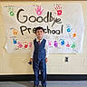 Muh joined the competition — help win amazing prizes! child, boy, preschool, graduation, banner, handprints, colorful, wall, clothing, vest, tie, shoes, smile, indoor, school, celebration, person, standing, floor, background