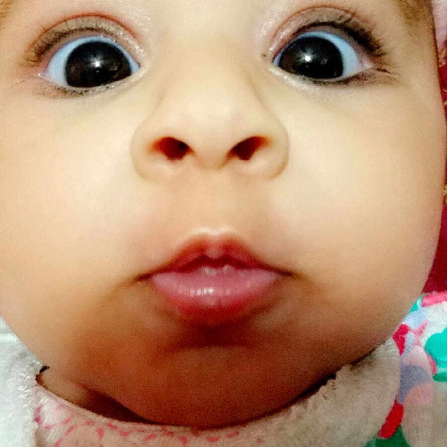 Laiba is registered to the contest to win money with this photo: baby, close_up, face, wide_eyes, chubby_cheeks, curious_expression, hat, clothing, colorful, pattern, infant, child, portrait, cute, soft_texture, warm, indoor, young, headwear, person