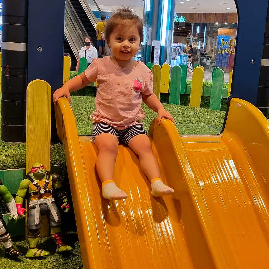 Yaran Ahmed is registered to the contest to win money with this photo: baby, ball, child, clothing, female, footwear, girl, indoors, outdoorplayarea, outdoors, person, playarea, shoe, shorts, slide, sphere, sport, tennis, tennisball, toy