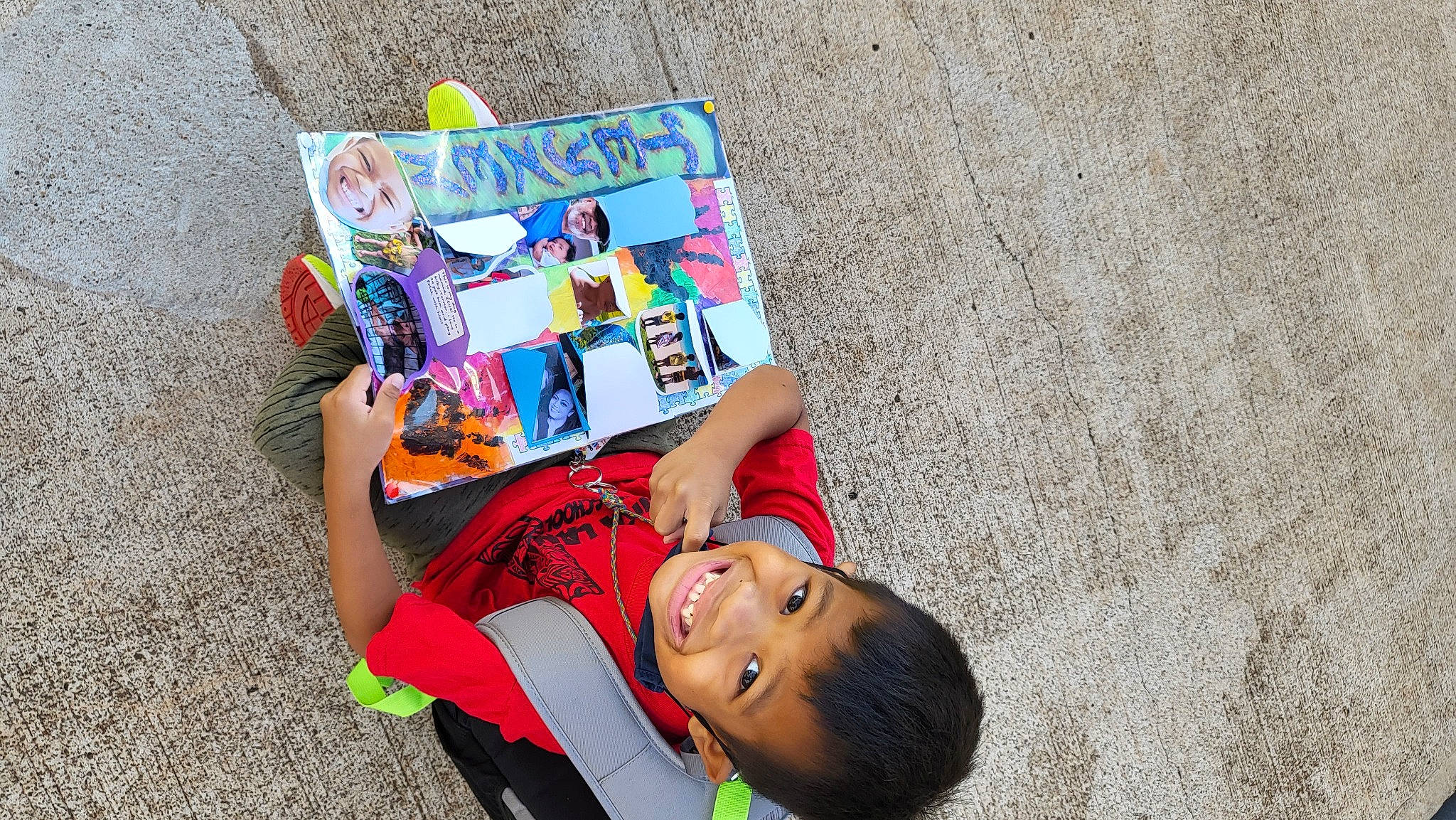 Teyzen is registered to the contest to win money with this photo: art, book, child, drawing, font, fun, grass, handwriting, happy, headwear, illustration, joy, leisure, person, play, publication, reading, recreation, sand, t_shirt