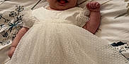 Freya Rose joined the competition — help win amazing prizes! baby, infant, smiling, white_dress, polka_dots, bedspread, floral_pattern, lying_down, happy, cute, small_fist, soft_lighting, indoors, child, person, portrait, sleepwear, sock_covered_feet, young_child, cheerful