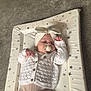 Freya Rose joined the competition — help win amazing prizes! baby, infant, pacifier, headband, knitted_sweater, changing_pad, star_pattern, carpet, table_leg, indoor, child, sleeping, cute, soft_lighting, baby_clothes, relaxing, lying_down, comfort, peaceful, small