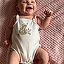 Freya Rose joined the competition — help win amazing prizes! baby, infant, smiling, white_onesie, pink_blanket, embroidery, cute, happy, child, lying_down, soft_texture, playful, barefoot, skin, portrait, indoors, young_child, joyful, raised_arm, natural_light
