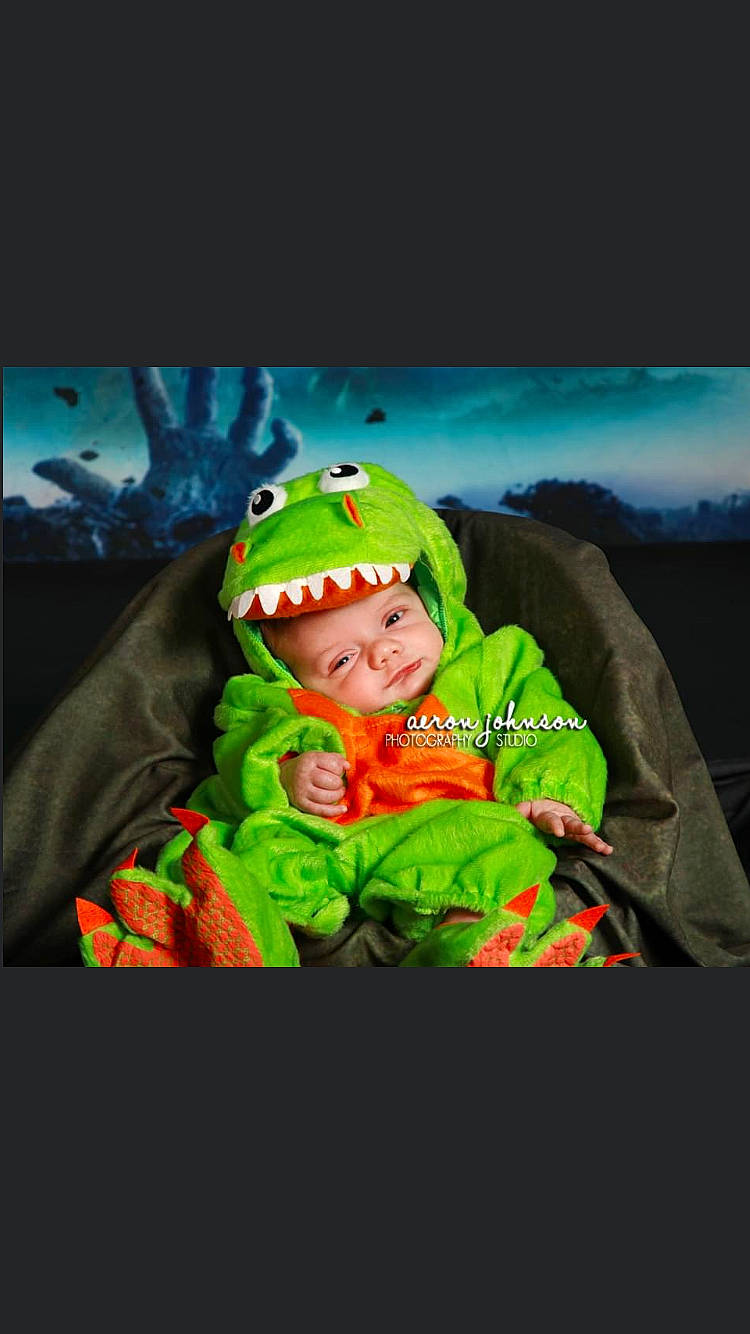 Grayson is registered to the contest to win money with this photo: baby, beanie, cap, child, event, flash_photography, fun, grass, happy, headgear, headwear, hoodie, knit_cap, landscape, magenta, person, personal_protective_equipment, sleeve, smile, toddler