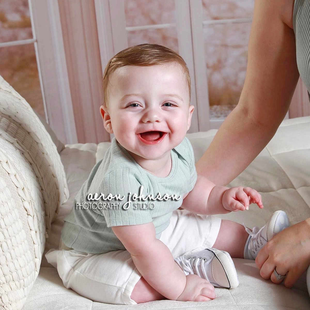 Grayson is registered to the contest to win money with this photo: baby, babylaughing, clothing, couch, cushion, face, footwear, furniture, happy, head, homedecor, laughing, newborn, pants, person, photography, portrait, shoe, sitting, smile
