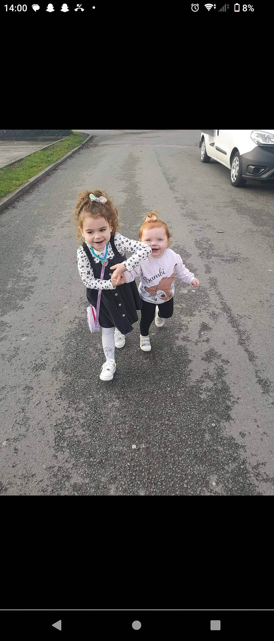 Esme is registered to the contest to win money with this photo: asphalt, automotive_exterior, baby, child, family_car, fun, gesture, grass, happy, joy, motor_vehicle, person, recreation, road, road_surface, sidewalk, smile, tar, tire, toddler