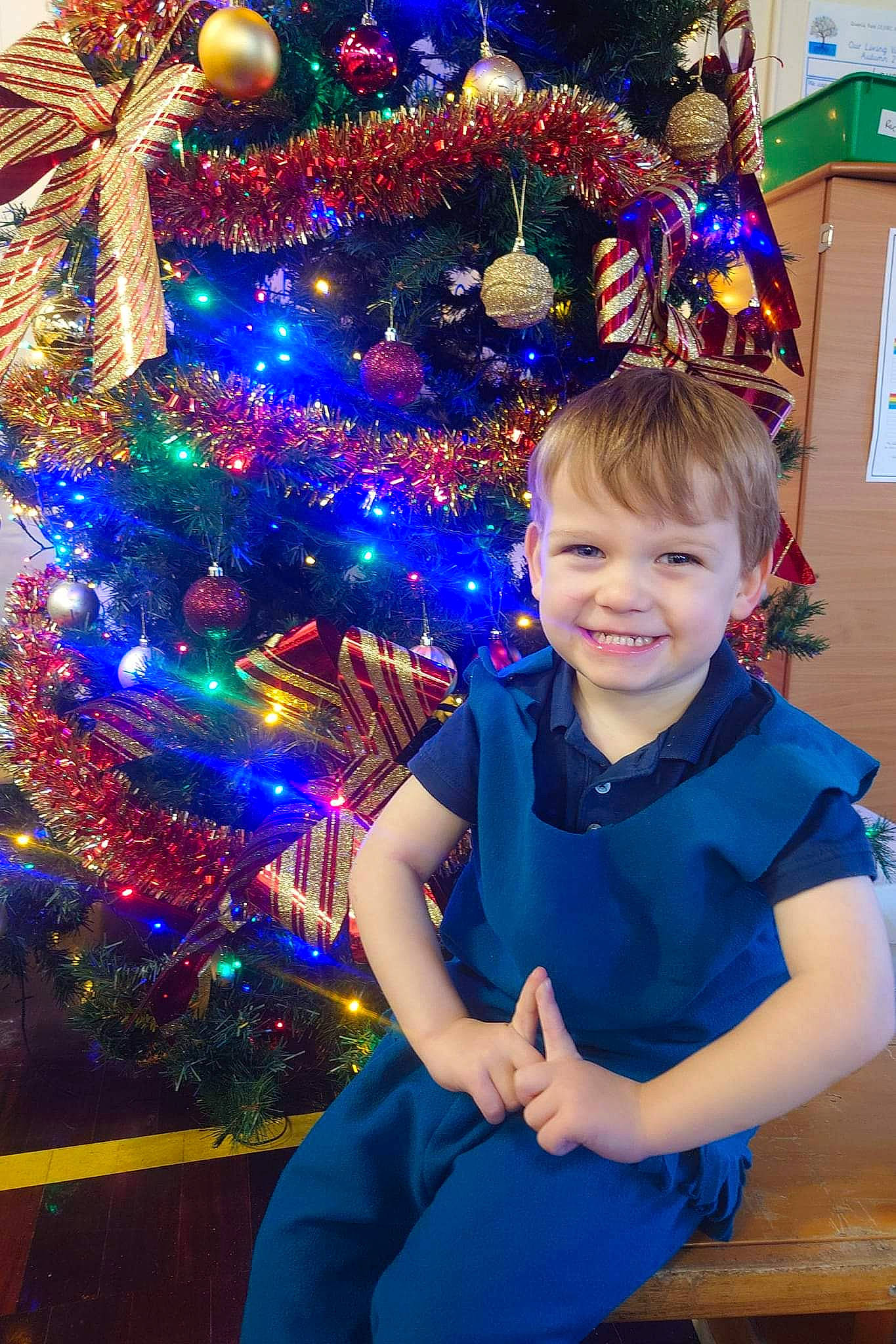 Freddie joined the competition — help win amazing prizes! blue, christmas_decoration, christmas_eve, christmas_ornament, christmas_tree, electric_blue, event, evergreen, facial_expression, fun, happy, holiday, holiday_ornament, joy, light, ornament, person, plant, smile, toddler