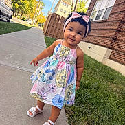 Arleth Meneses is registered to the contest to win money with this photo: toddler, child, sidewalk, dress, floral_pattern, headband, pink_bow, sandals, grass, brick_building, tree, sunlight, outdoor, curly_hair, smile, cute, urban, daytime, person, portrait