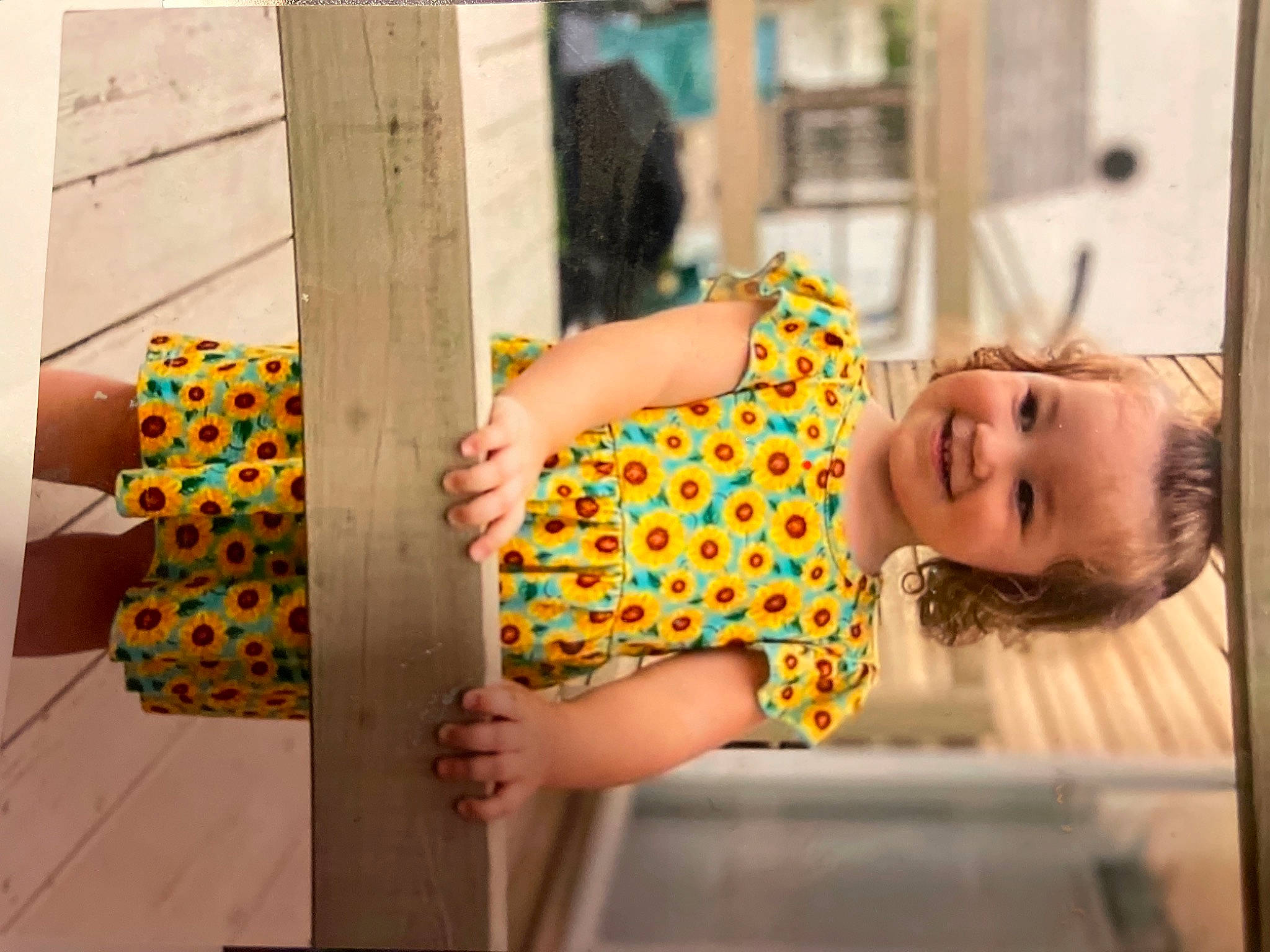 Camille is registered to the contest to win money with this photo: baby, baby_toddler_clothing, child, fun, happy, human_leg, indoor_games_and_sports, joy, leisure, pattern, person, play, recreation, room, shorts, sitting, t_shirt, textile, thigh, toddler