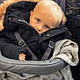 Oakley joined the competition — help win amazing prizes! child, baby, stroller, blanket, fur_hood, jacket, straps, face, blonde_hair, blue_eyes, winter_clothing, cozy, indoors, seated, cute, portrait, warm, snug, toddler, soft_texture