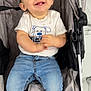 Tiago a rejoint le concours — aidez-le/la à gagner de superbes lots ! baby, child, smiling, stroller, jeans, tshirt, happy, cute, infant, seated, clothing, footwear, indoor, portrait, person, baby_teeth, baby_smile, fabric, seat, childcare