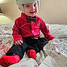 Wesley joined the competition — help win amazing prizes! baby, child, helmet, bow_tie, red_shirt, black_trousers, red_socks, smiling, portrait, sitting, bed, bedroom, blanket, floral_bedding, indoor, infant, protective_gear, fashion, happy, photography