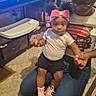 Kalaya joined the competition — help win amazing prizes! toddler, woman, child, pink_bow, sneakers, television, cartoon, carpet, indoor, holding_hands, baby, casual_clothing, glasses, hair_bun, furniture, table, room, family, playful, home