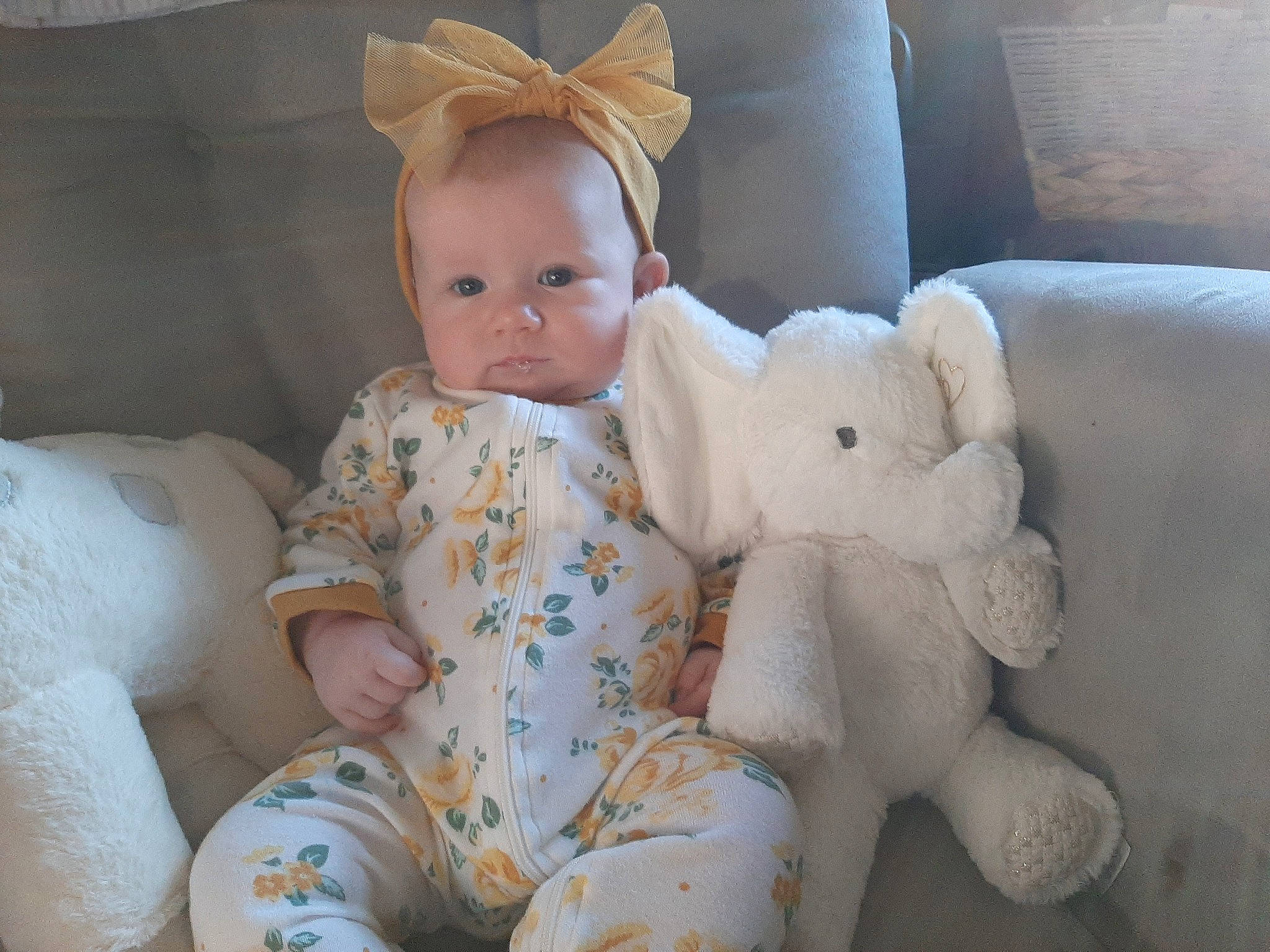 Ellora is registered to the contest to win money with this photo: baby, baby_sleeping, baby_toddler_clothing, cheek, child, comfort, costume_hat, couch, eye, hat, head, human_body, linens, person, room, sitting, skin, stuffed_toy, textile, toddler