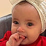 Liva participe au concours pour gagner de l'argent avec cette photo : baby, infant, child, face, eyes, eyelashes, hand, fingers, mouth, headband, bow, red_clothing, portrait, close_up, candid, teething, skin, indoor, cozy, chair