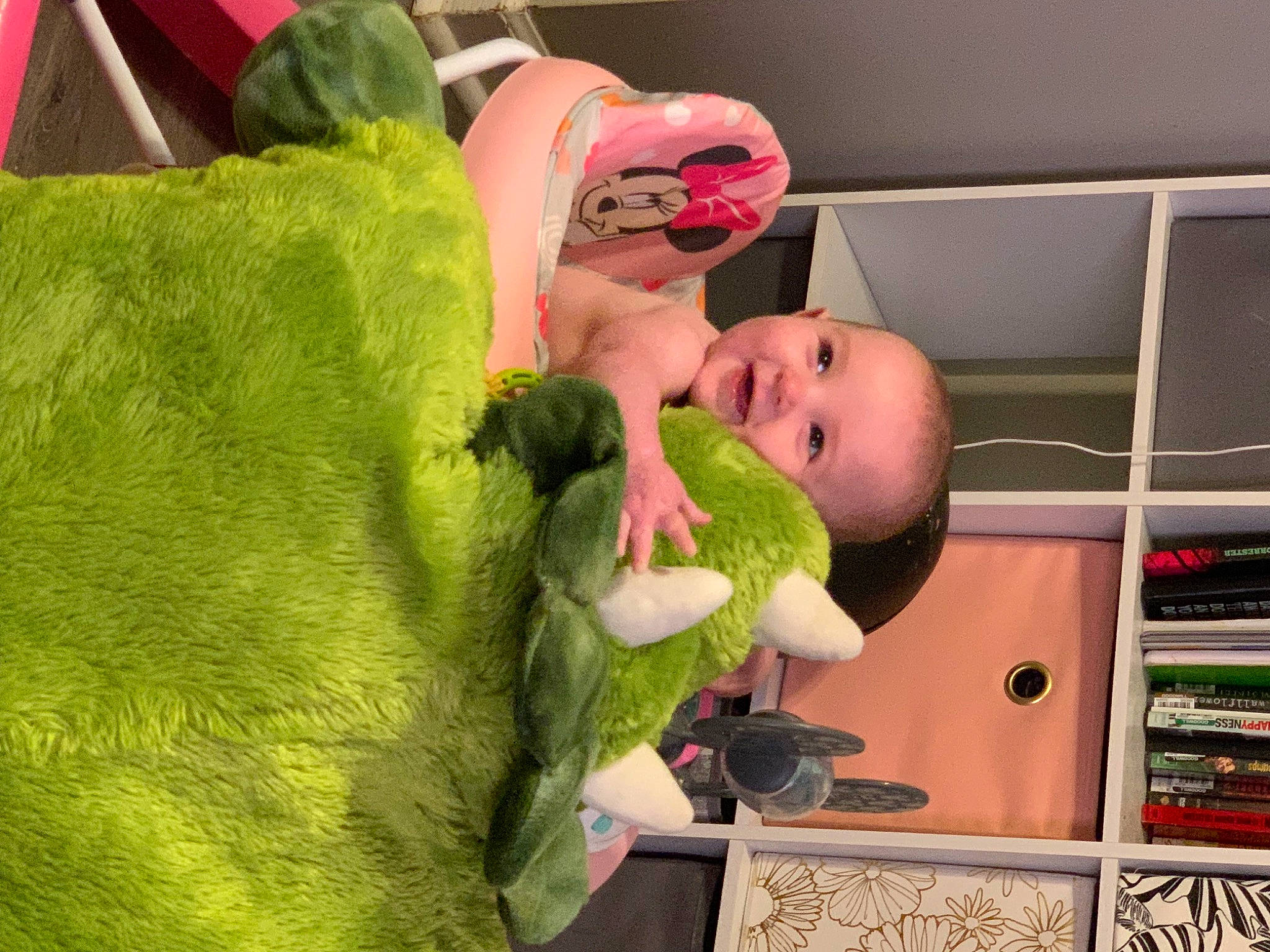 Delilah is registered to the contest to win money with this photo: baby, baby_products, bookcase, child, comfort, fruit, fun, fur, happy, leisure, magenta, natural_foods, person, pink, plush, room, shelf, stuffed_toy, toddler, toy