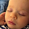baby, blanket, cheeks, close_up, clothing, eyelashes, eyes_closed, face, hand, indoor, infant, lips, nose, peaceful, photography, portrait, resting, sleeping, sleepy, striped_shirt