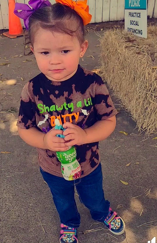 Aurora joined the competition — help win amazing prizes! agriculture, baby, baby_toddler_clothing, bottle, child, cool, drink, eye, hair_accessory, hay, headband, headpiece, jeans, person, plastic_bottle, shoe, sneakers, straw, sweatpant, toddler