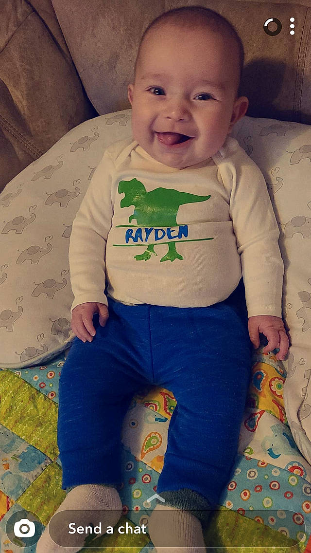 Rayden is registered to the contest to win money with this photo: baby, baby_laughing, baby_making_funny_faces, baby_products, baby_toddler_clothing, baby_toys, cheek, child, couch, fictional_character, human, humour, laugh, living_room, nightwear, person, slipcover, sock, toddler, tongue