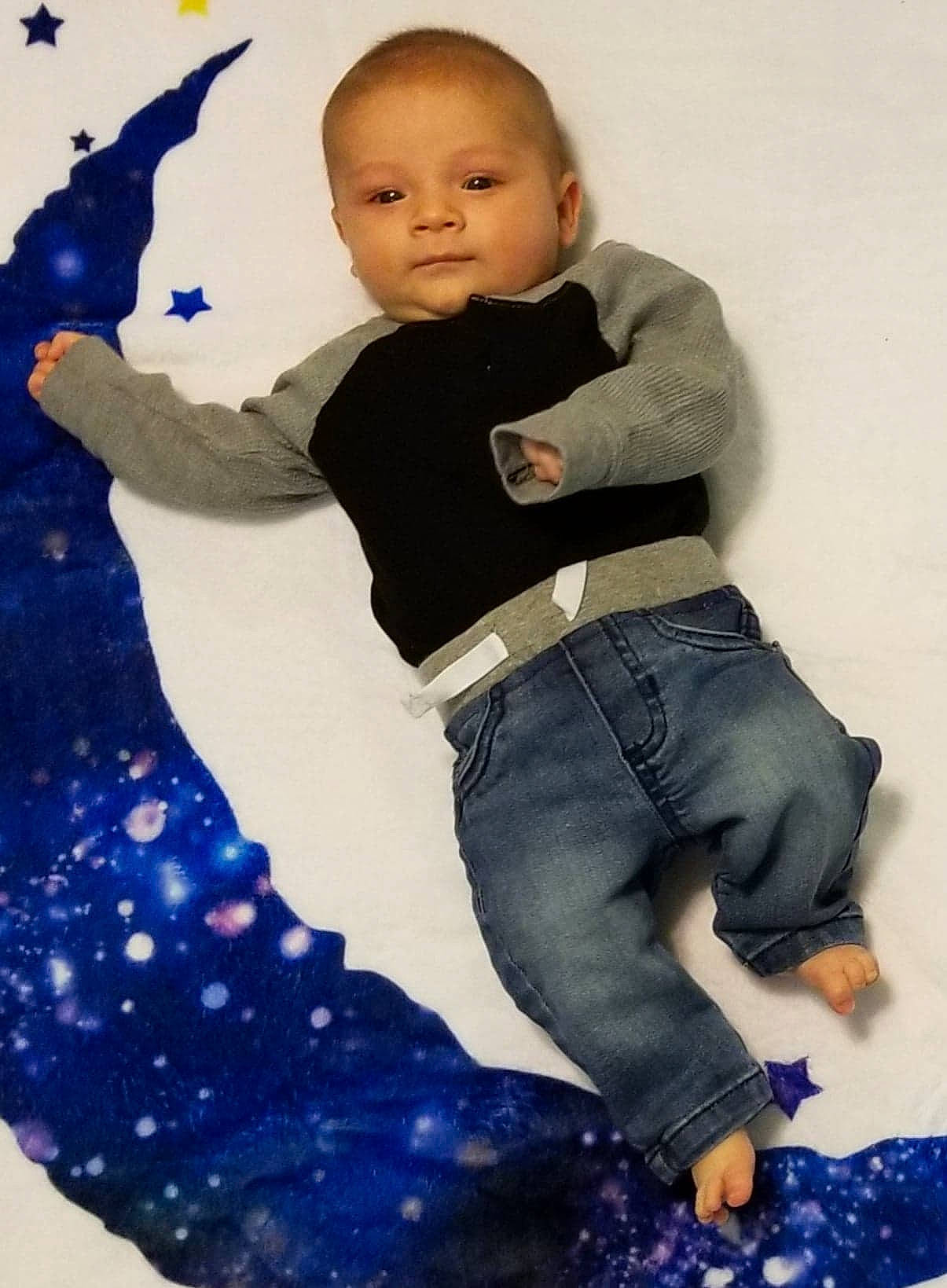 Nikolas is registered to the contest to win money with this photo: ankle, baby, baby_products, baby_toddler_clothing, barefoot, blue, cheek, denim, ear, finger, foot, jeans, joint, person, pocket, sitting, textile, toddler, toe