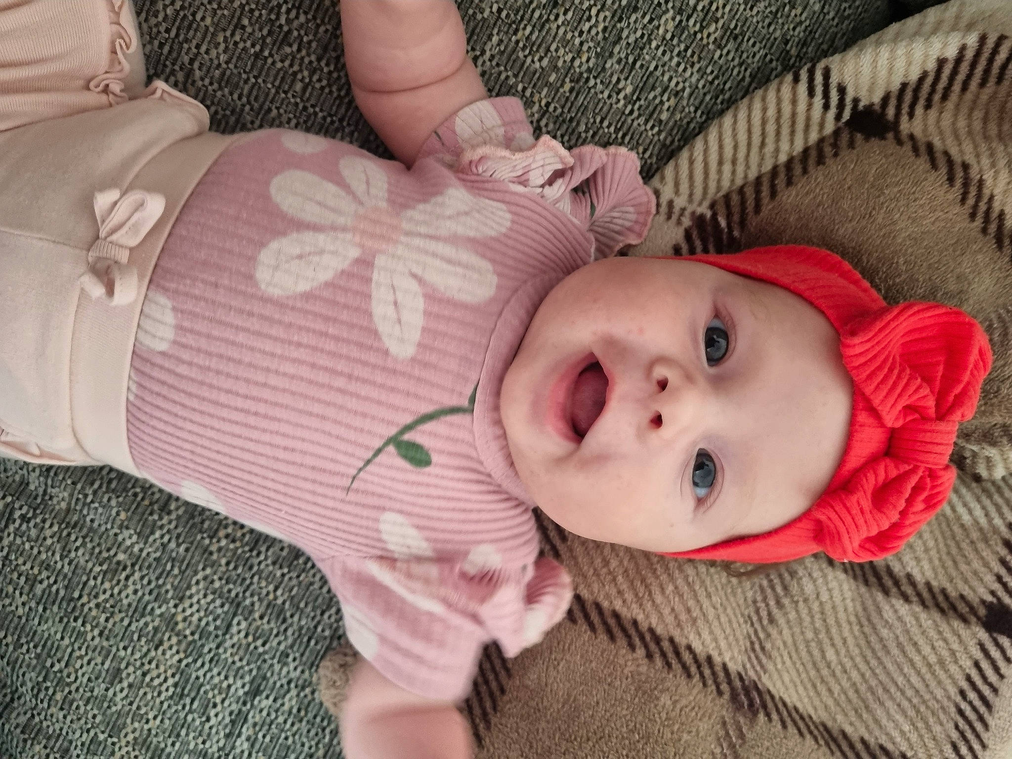 Gabriela is registered to the contest to win money with this photo: baby, baby_toddler_clothing, cheek, comfort, eye, facial_expression, hand, head, headgear, headwear, human_body, iris, lip, mouth, nose, person, pink, skin, sleeve, textile