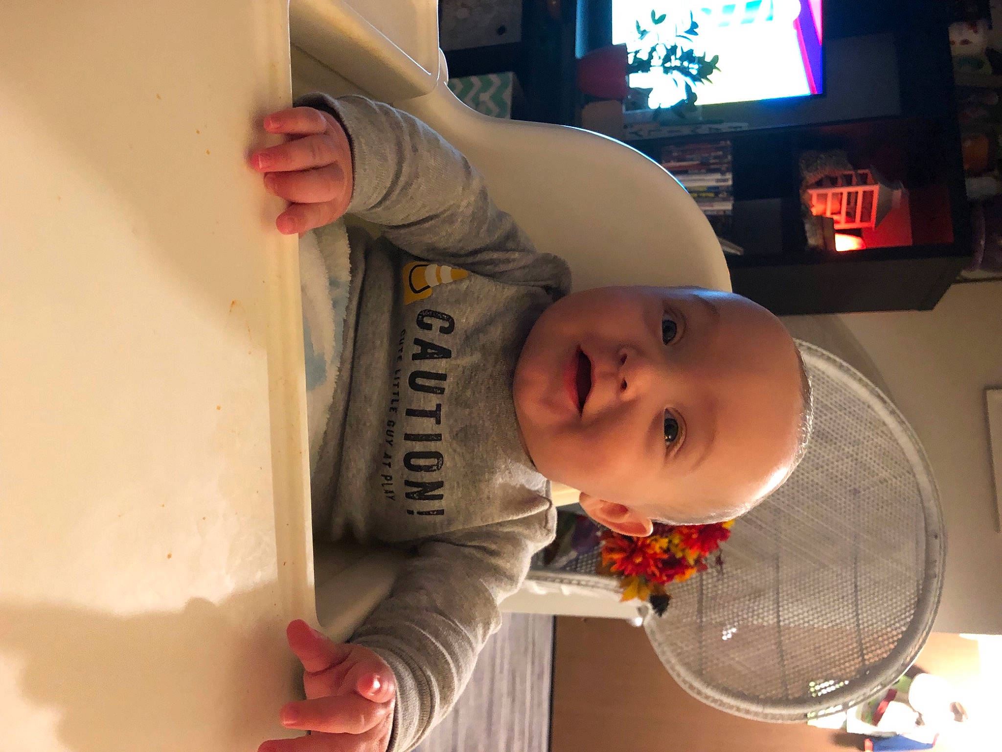 Blayke is registered to the contest to win money with this photo: baby, baby_products, baby_toddler_clothing, chair, cheek, child, display_device, fun, hat, headgear, home_appliance, lighting_accessory, mouth, nose, person, product, room, smile, standing, television