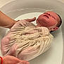 Achille a rejoint le concours — aidez-le/la à gagner de superbes lots ! newborn, baby, infant, bathtub, water, hands, wrapped, cloth, skin, gentle, care, bath, relaxation, human, person, tender, peaceful, closeup, support, parental_care