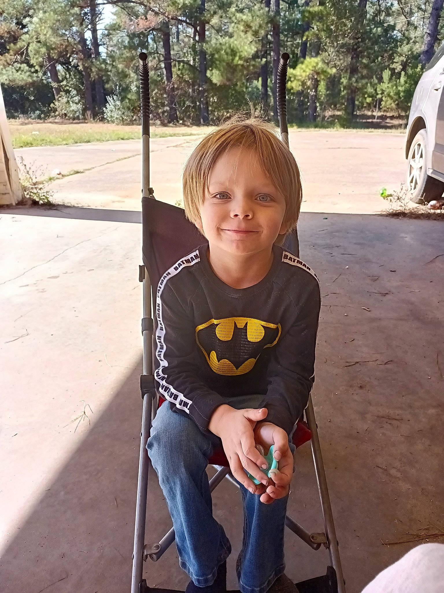 Alexander is registered to the contest to win money with this photo: chair, child, city, cool, fun, jeans, joy, leisure, outdoor_play_equipment, person, plant, public_space, recreation, sitting, sleeve, smile, t_shirt, toddler, tree, vacation