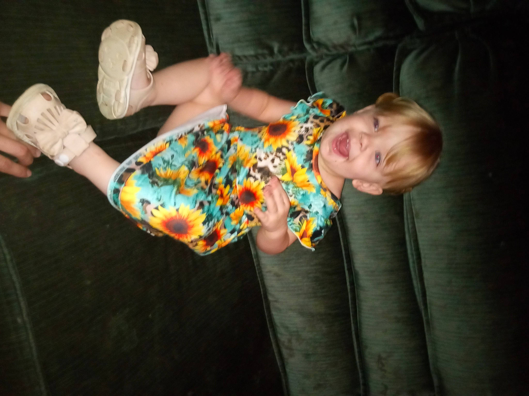 Emma is registered to the contest to win money with this photo: baby, baby_toddler_clothing, child, comfort, dress, finger, foot, fun, hand, head, human_leg, nail, pattern, person, sitting, sleeve, thigh, toddler, tree, wood