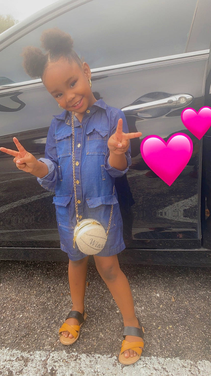 Dalani joined the competition — help win amazing prizes! child, denim, electric_blue, finger, fun, gesture, happy, human_leg, joint, joy, knee, motor_vehicle, person, shorts, shoulder, sleeve, standing, street_fashion, t_shirt, thumb