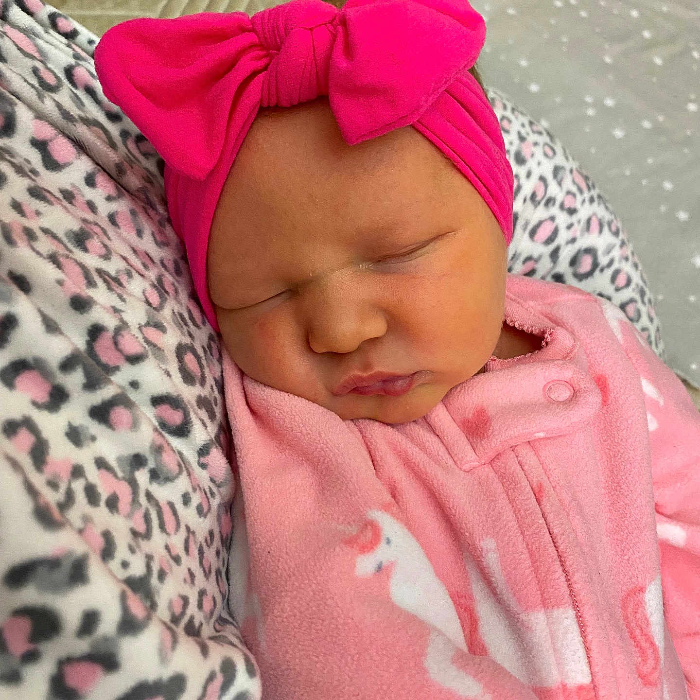 Kambrye is registered to the contest to win money with this photo: newborn, baby, sleeping, pink, headband, bow, onesie, unicorn, blanket, leopard_print, soft, cozy, portrait, infant, cute, peaceful, closeup, child, resting, clothing