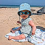 Malone participe au concours pour gagner de l'argent avec cette photo : baby, beach, sand, blanket, hat, sunglasses, smile, sunny, ocean, water, summer, child, outdoor, vacation, sunhat, foot, clothing, relaxation, nature, portrait