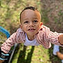 child, smiling, outdoor, grass, shirt, white_tshirt, striped_shirt, happy, face, person, young_child, portrait, daylight, casual_clothing, cute, boy, expression, looking_up, sunlight, playful