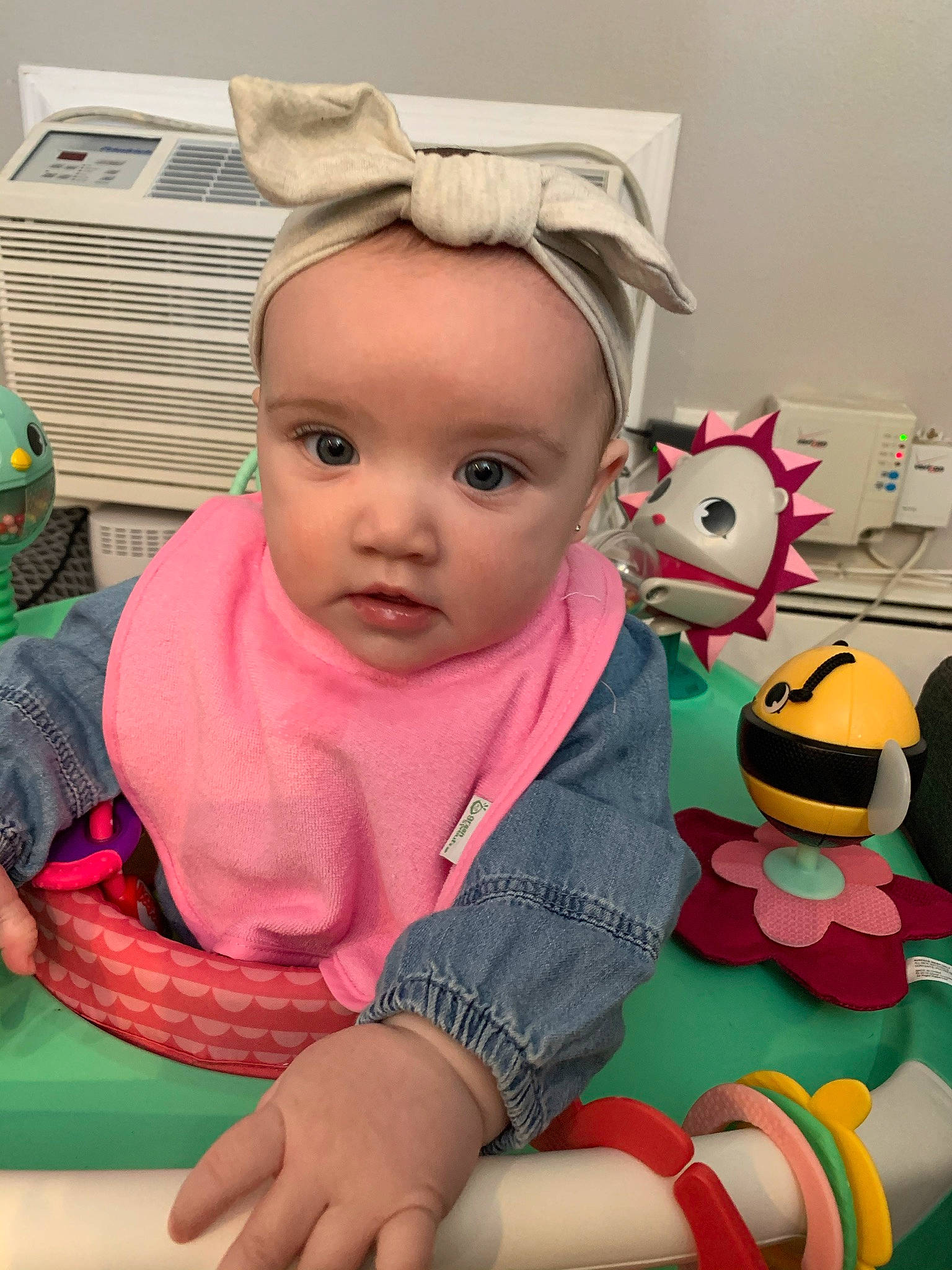 Mila Michele is registered to the contest to win money with this photo: baby, baby_products, baby_toddler_clothing, cheek, child, facial_expression, finger, flooring, fun, happy, mouth, nose, person, pink, play, room, sitting, skin, stuffed_toy, toddler