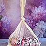Justina is registered to the contest to win money with this photo: baby, newborn, sleeping, floral_blanket, hanging_net, purple_background, flowers, soft_fabric, infant, portrait, peaceful, wrapped, cute, studio_photo, delicate, resting, indoor, baby_photography, blanket, child