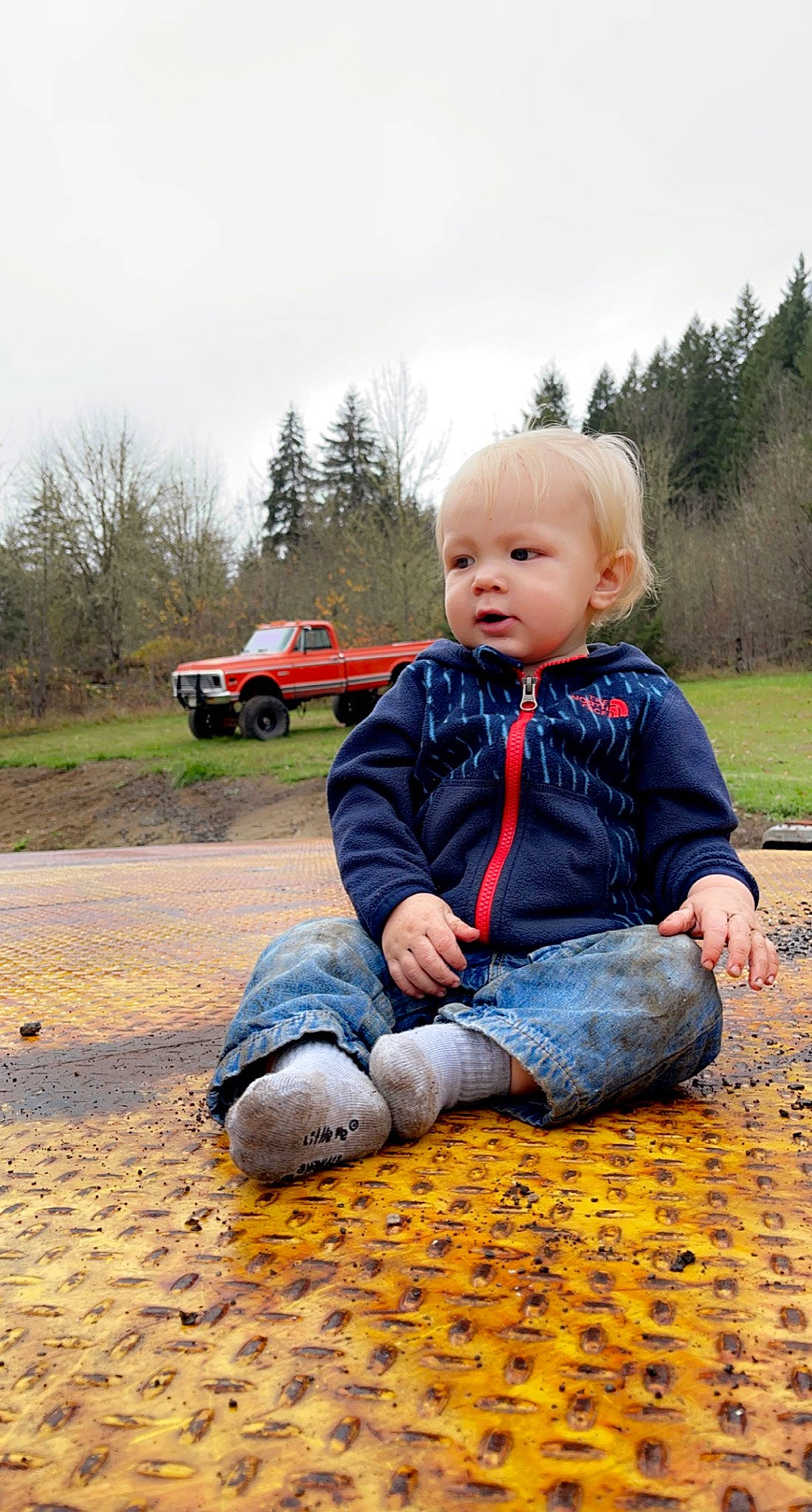 Cleo is registered to the contest to win money with this photo: baby, baby_toddler_clothing, car, child, fun, grass, happy, landscape, leisure, people_in_nature, person, plant, recreation, sitting, sky, tire, toddler, tree, vehicle, wheel