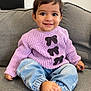 Samara joined the competition — help win amazing prizes! toddler, child, smiling, sitting, couch, sweater, purple, denim, barefoot, happy, indoors, face, person, clothing, cute, young_child, hair, casual, relaxed, portrait