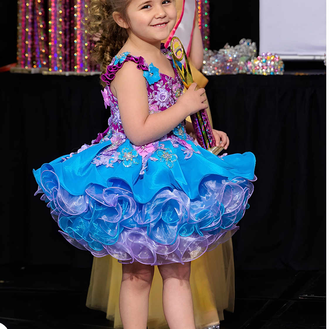 Aubriellah is registered to the contest to win money with this photo: award, blue_dress, celebration, child, competition, curly_hair, dress, event, fashion, frilly_dress, girl, happy, pageant, person, portrait, smiling, sock, stage, trophy, white_shoes