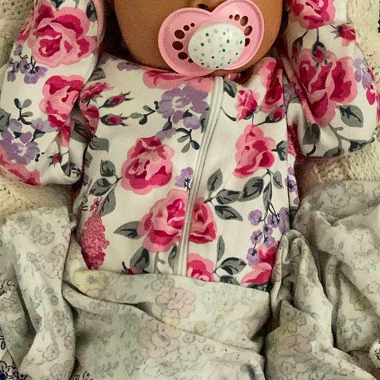 Eiley is registered to the contest to win money with this photo: baby, blanket, closeup, comfort, cute, face, floral, floral_pajamas, indoor, infant, knitted_blanket, lying_down, mittens, newborn, pacifier, pattern, person, resting, sleepwear, soft