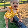 Delilah joined the competition — help win amazing prizes! toddler, child, swimsuit, yellow, floral_pattern, smiling, happy, outdoor, playground, grass, summer, barefoot, person, cute, young_child, daylight, fun, expression, balance, park