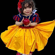 Amelia is registered to the contest to win money with this photo: child, toddler, costume, snow_white, dress, yellow_skirt, red_shoes, apple, smile, curly_hair, headband, red_bow, portrait, isolated, studio_style, cute, happy, fairy_tale, young_girl, black_background