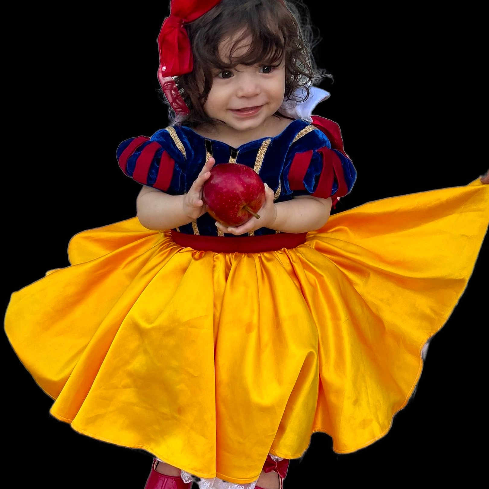Amelia is registered to the contest to win money with this photo: apple, black_background, child, costume, curly_hair, cute, dress, fairy_tale, happy, headband, isolated, portrait, red_bow, red_shoes, smile, snow_white, studio_style, toddler, yellow_skirt, young_girl