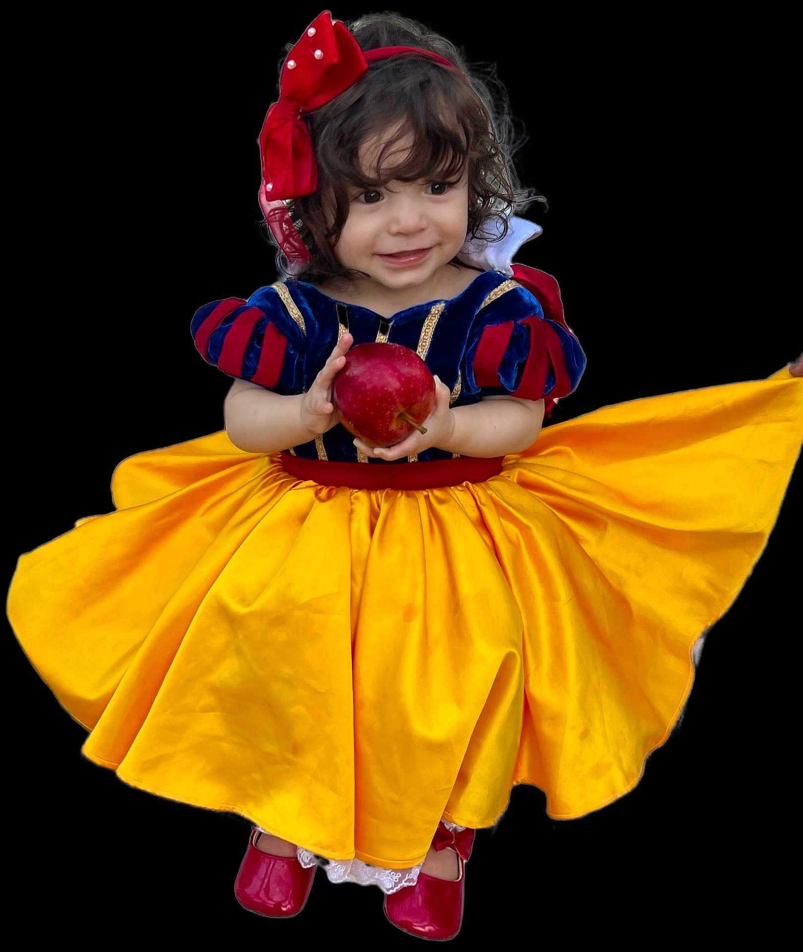 Amelia is registered to the contest to win money with this photo: child, toddler, costume, snow_white, dress, yellow_skirt, red_shoes, apple, smile, curly_hair, headband, red_bow, portrait, isolated, studio_style, cute, happy, fairy_tale, young_girl, black_background